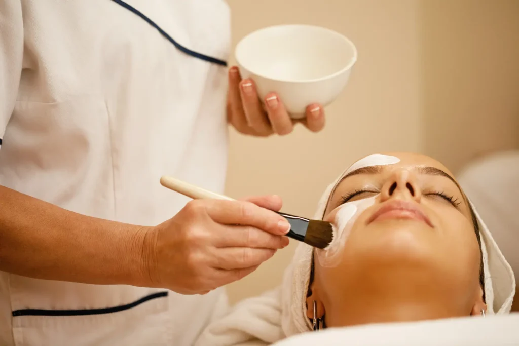 unrecognizable beautician applying mask on woman s 2024 12 13 17 40 58 utc
